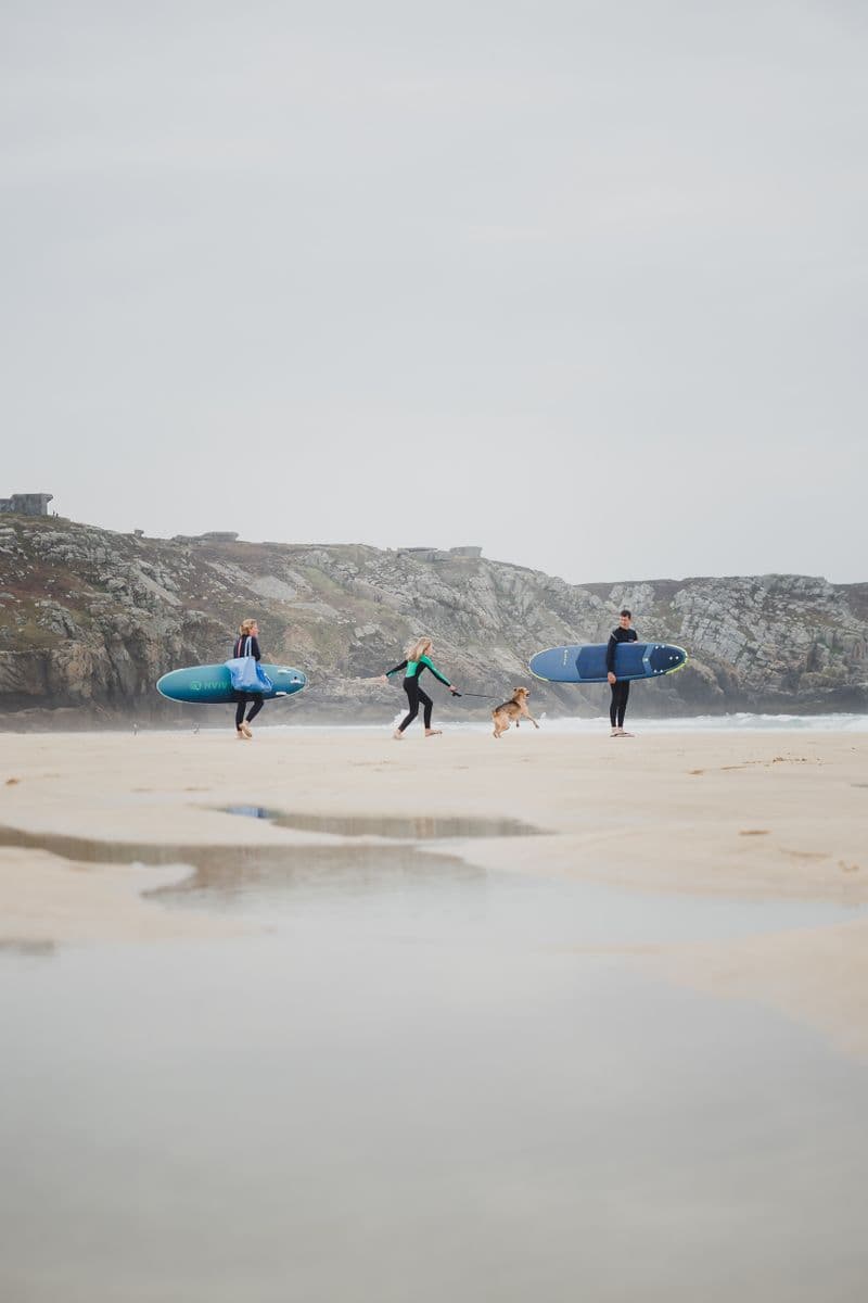 Surfistas caminando por una playa atlántica